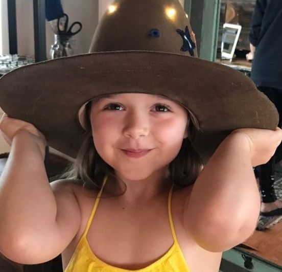 Harper Beckham in yellow dress and cowgirl hat