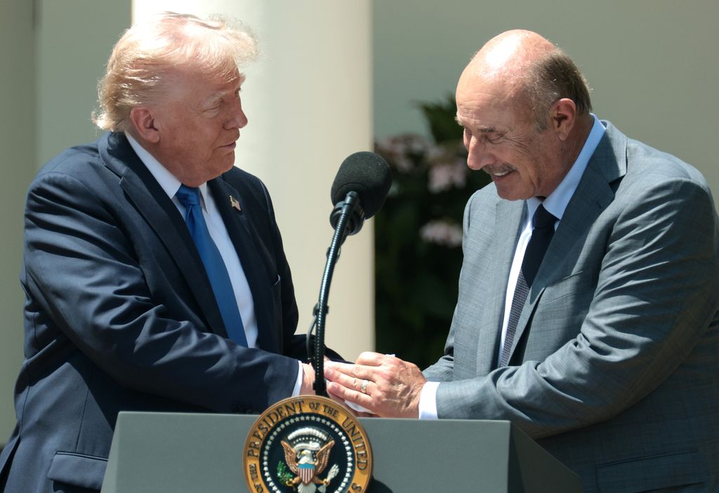 U.S. President Donald Trump (L) shakes hands with Dr. Phil McGraw as he delivers remarks during a National Day of Prayer event in the Rose Garden at the White House on May 1, 2025 in Washington, DC. The National Day of Prayer is a congressionally recognized observance that calls on people of all faiths to participate in a day of prayer and reflection