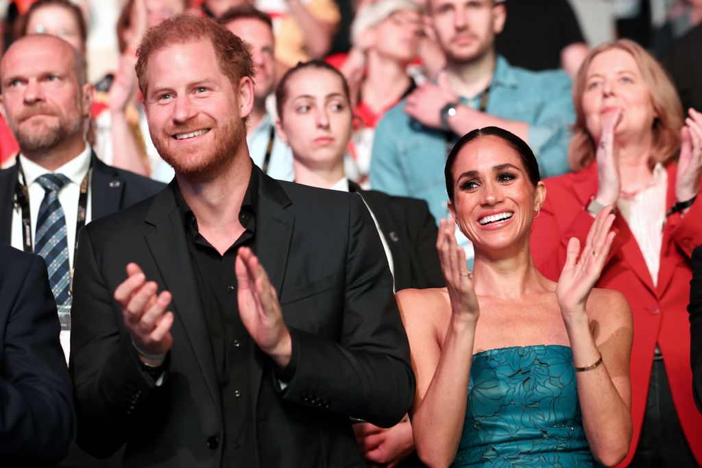 Prince Harry and Meghan Markle clapping hands