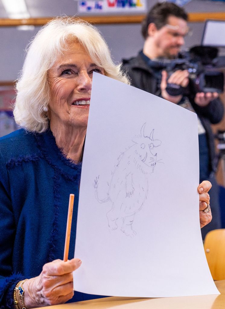 Queen Consort Camilla holding up her drawing
