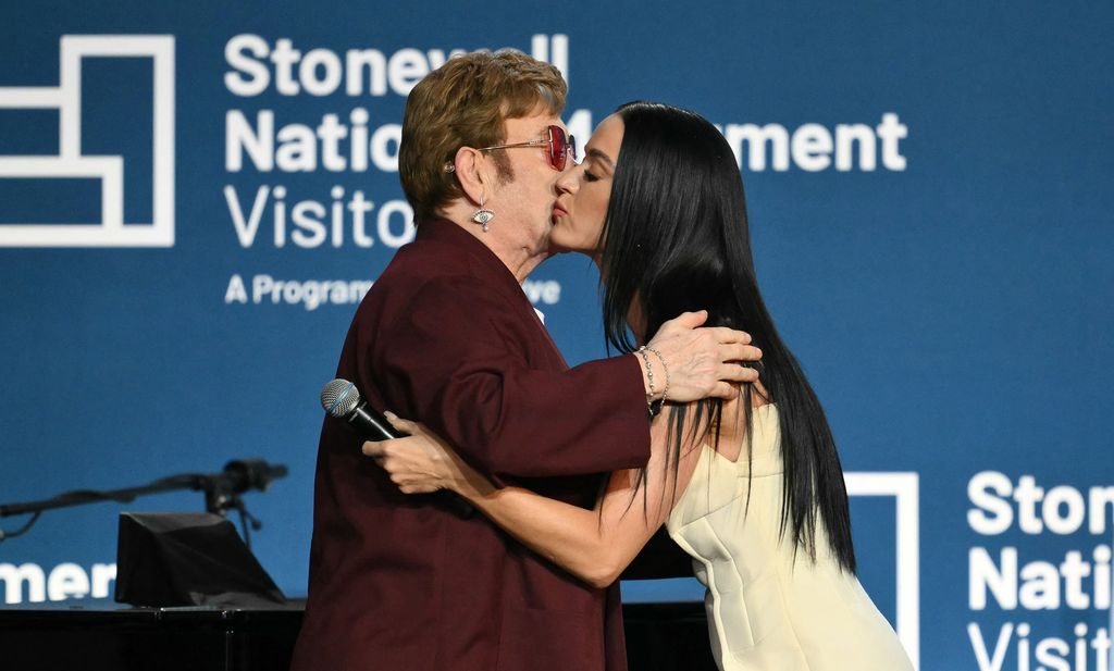 Katy Perry and Elton John kiss on stage at the Stonewall National Monument Visitor Center grand opening ceremony