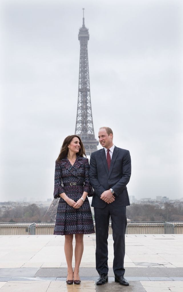 The duo pose in front of the Eiffel Tower at the Trocadero square on March 18, 2017 in Paris