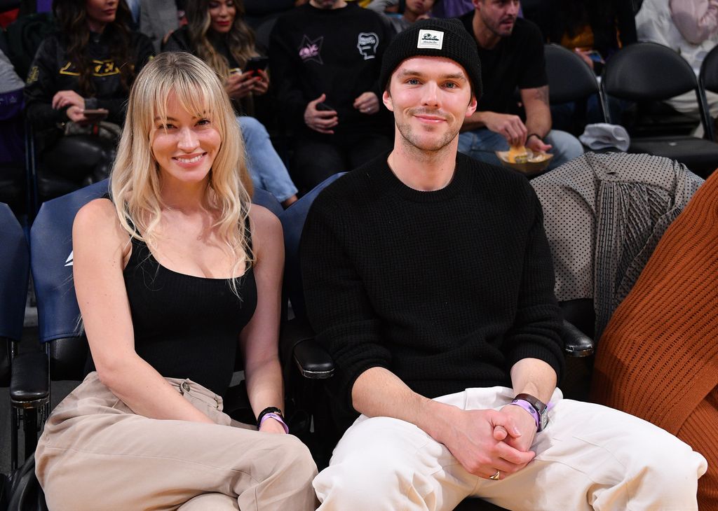Nicholas Hoult and Bryana Taylor  at a basketball game in 2023