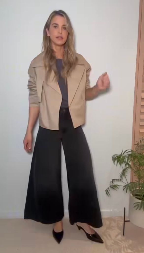 Vogue posed in the cropped trench coat in an Instagram Reel