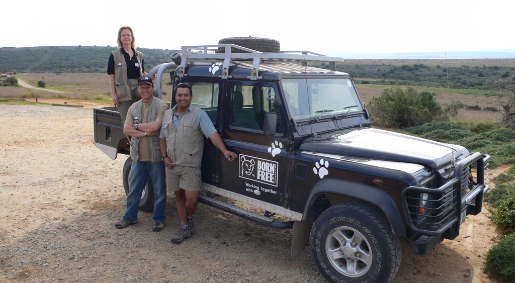Jenny and two men on safari van in africa