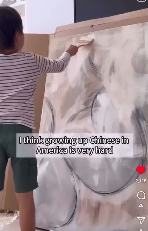 A young child painting on a canvas