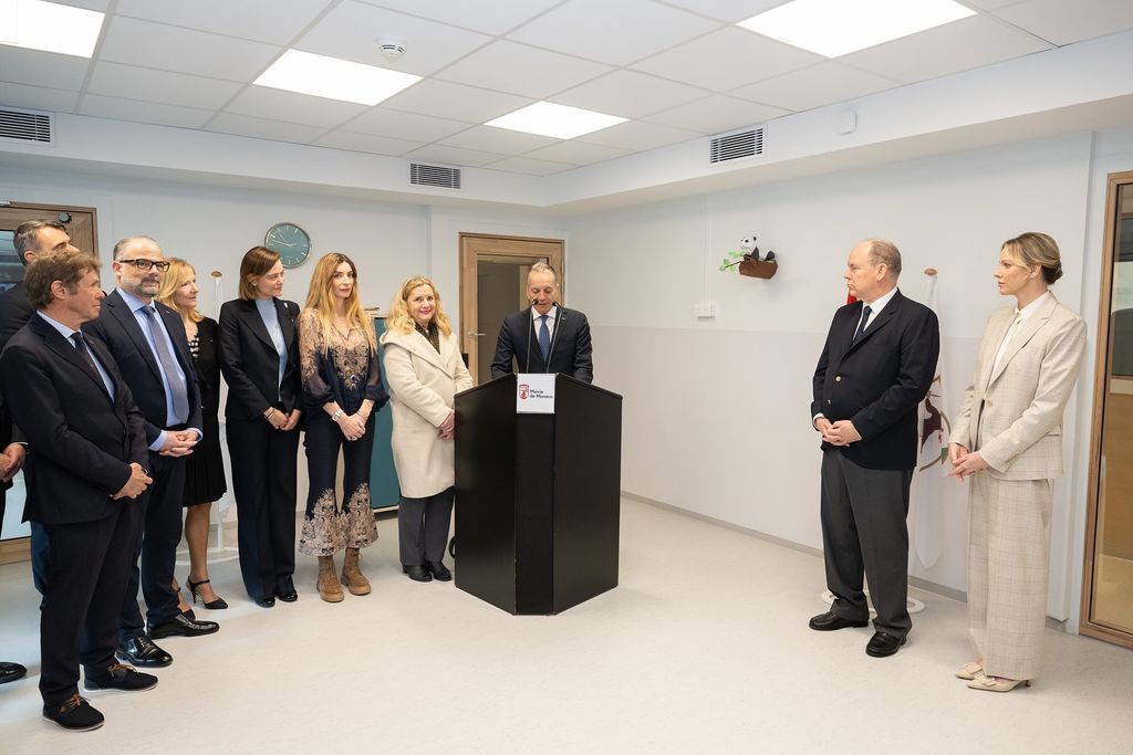 Princess Charlene and Prince Albert standing with staff memebers at the Monte-Carlo Nursery