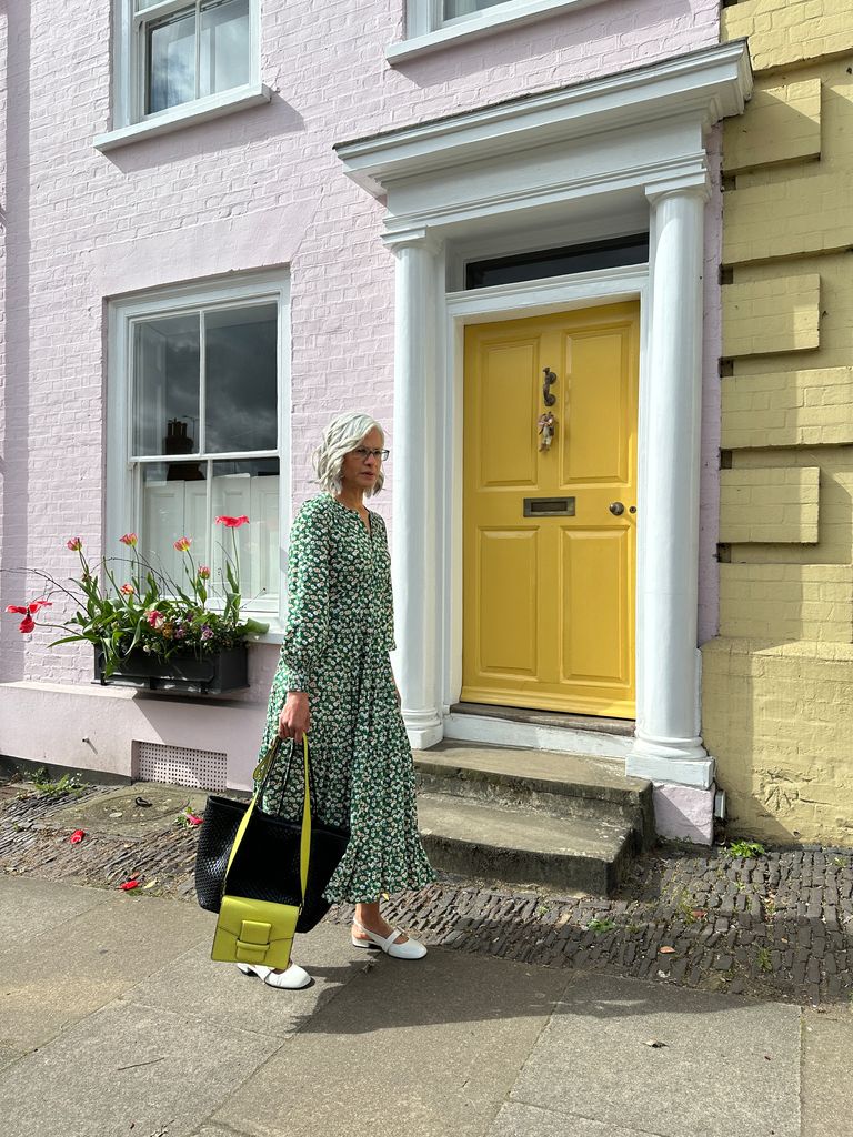 Woman walking outside with a yellow bag