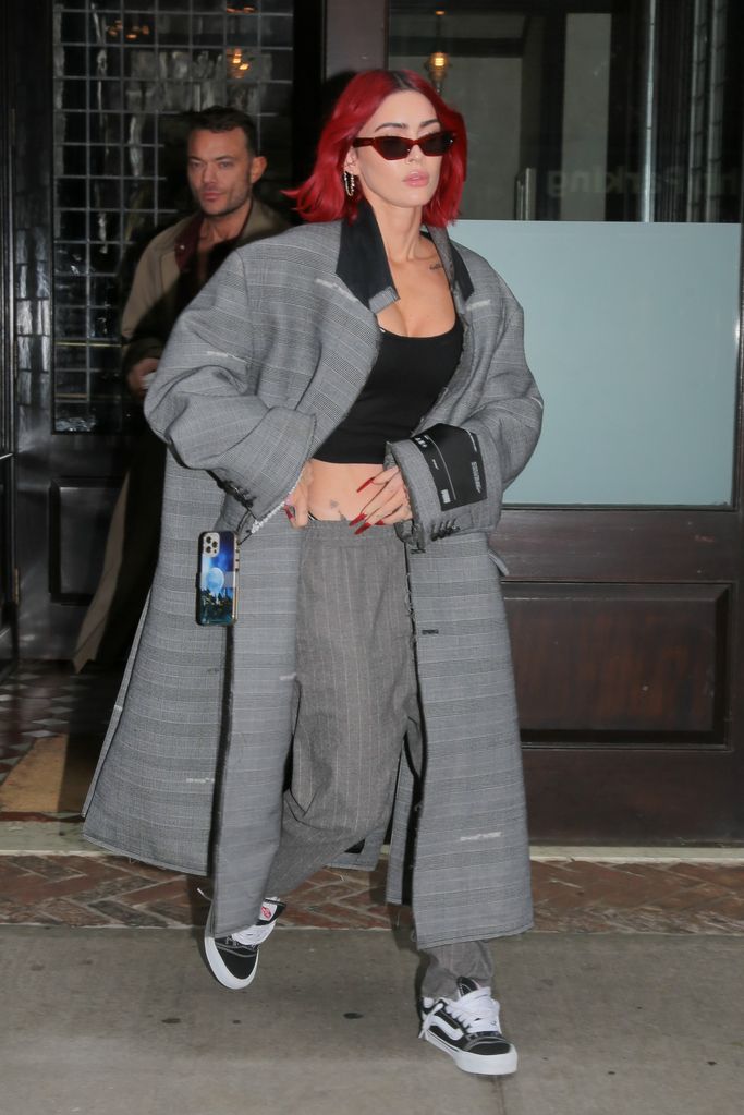 Megan Fox in grey oversized coat and grey trousers with red hair