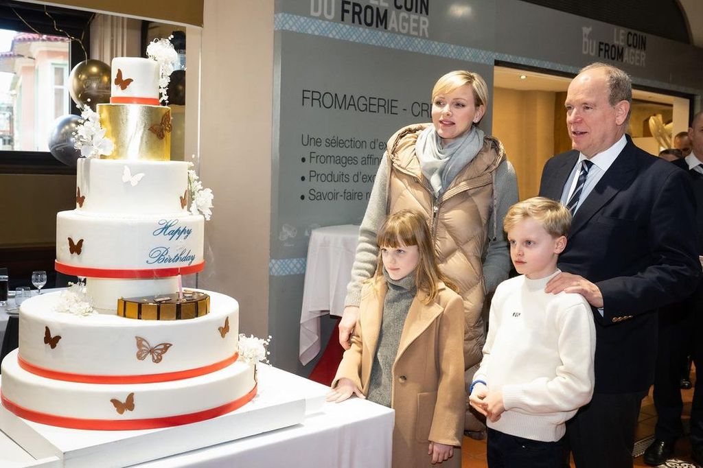 Monaco royals stand and look at six-tier cake during outing for Princess Charlene's birthday