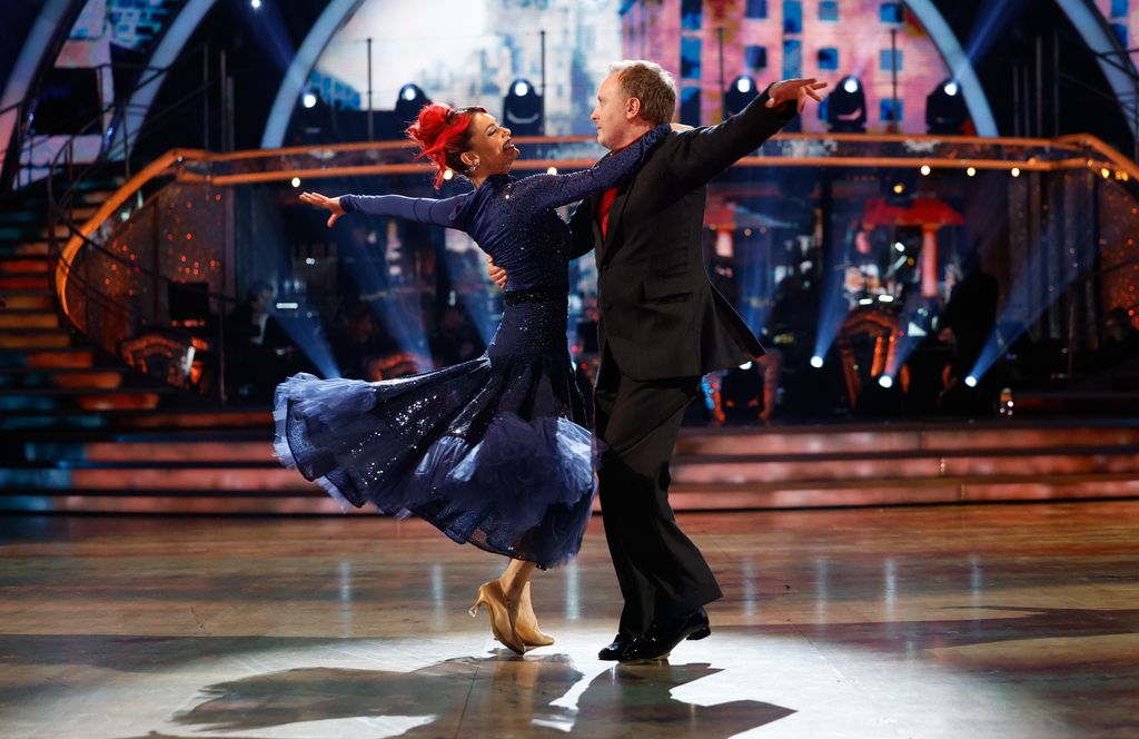 couple dancing waltz on stage