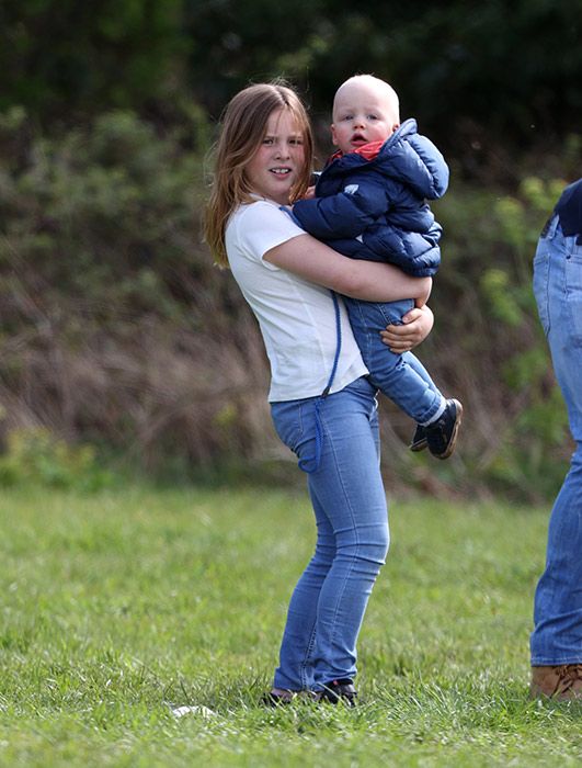 Mia Tindall holding his baby brother Lucas in her arms