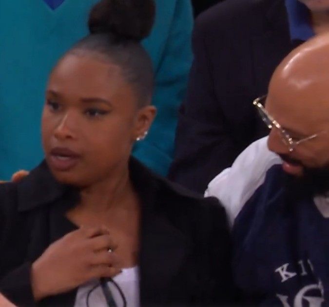 jennifer hudson looking away while common wraps arm around her shoulder