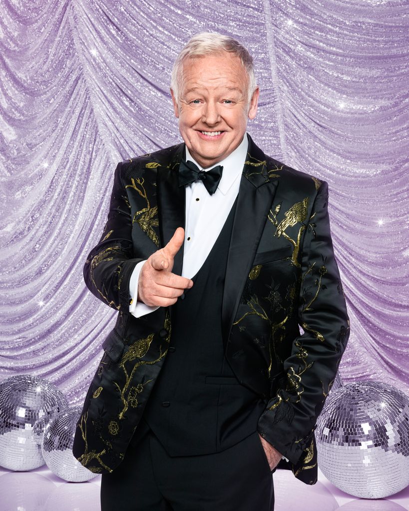 Les Dennis points finger as he poses for Strictly portrait