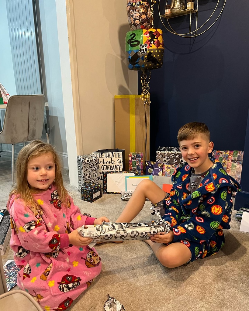 Izzi's living room with a navy accent wall with kids and birthday presents