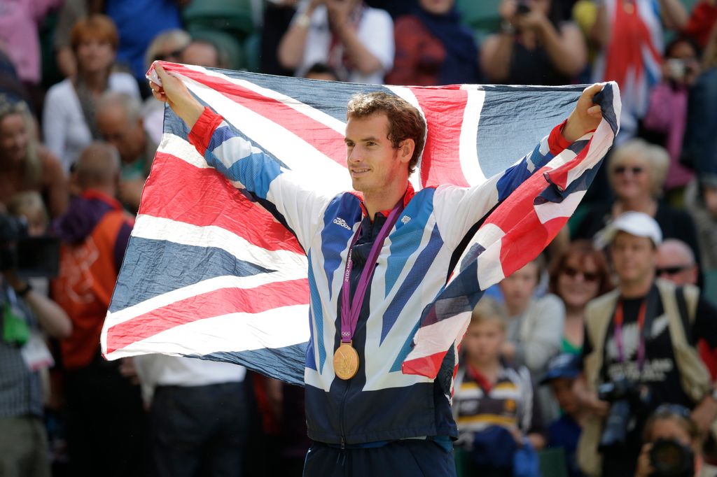 Andy Murray carrying the Union Jack and wearing a gold medal