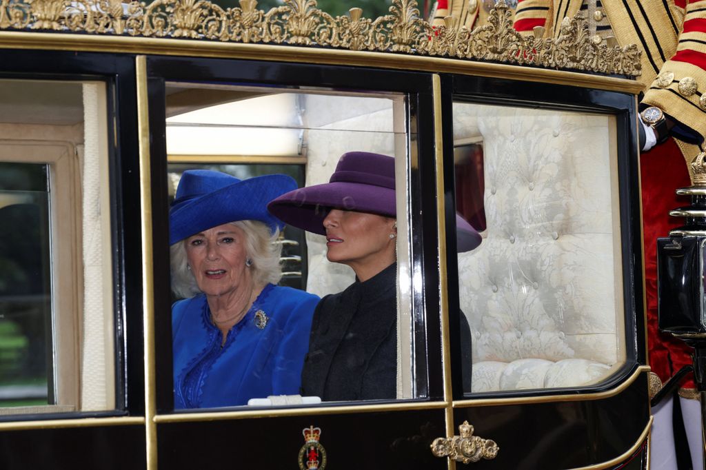 Queen Camilla and Melania Trump sit in a carriage during a procession through Windsor Castle