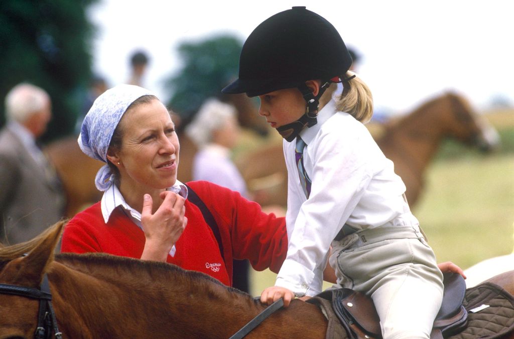 Princess Anne encourages her daughter as she rides a horse for the first time