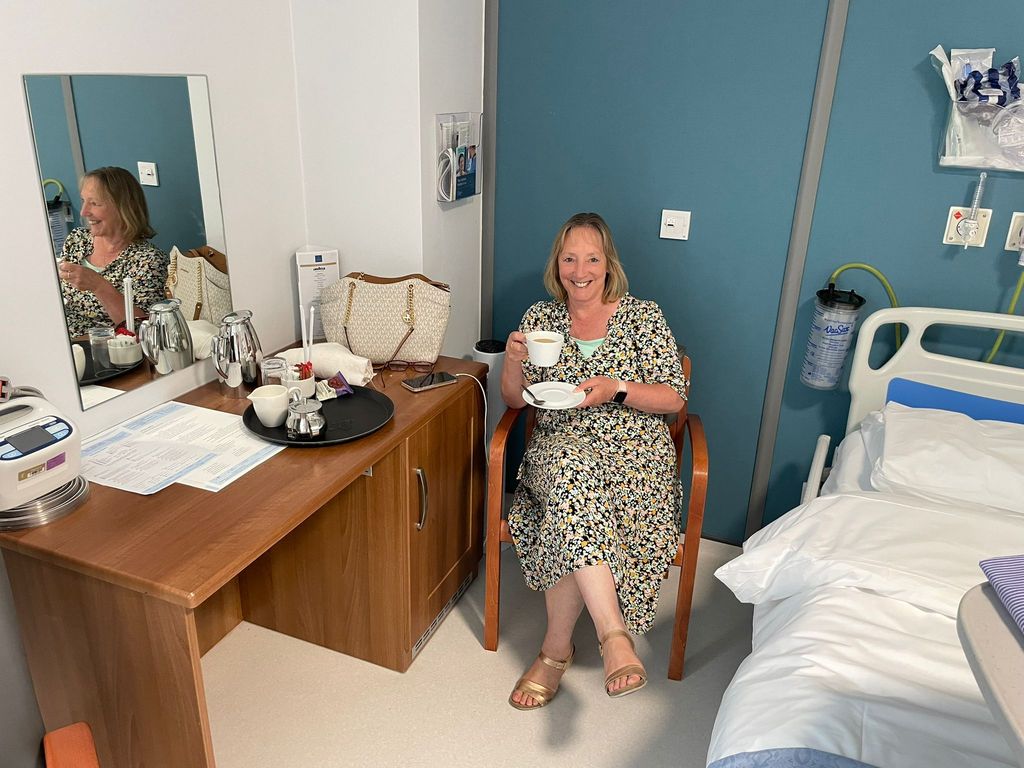 A photo of Samantha Lawrence sitting in a hospital room 