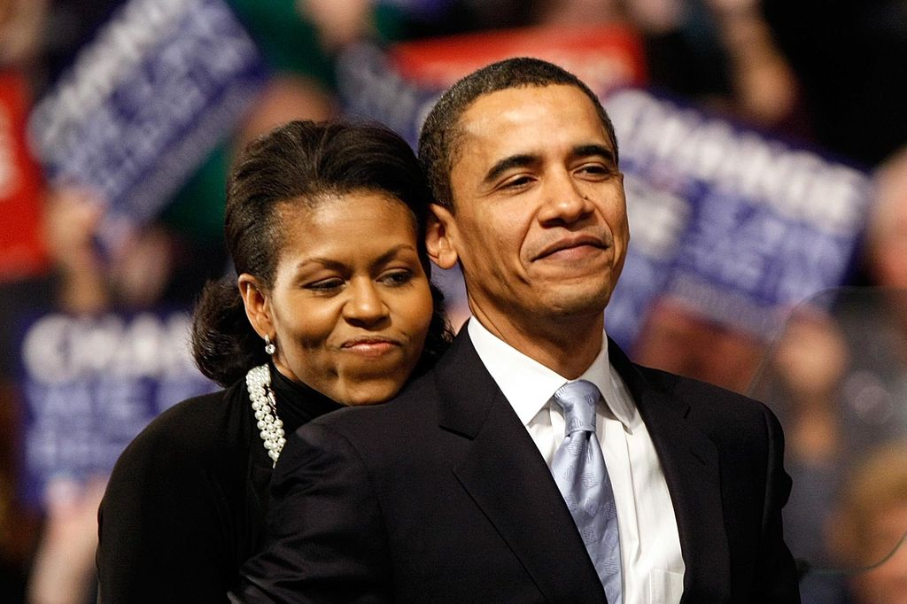 Democratic presidential hopeful Sen. Barack Obama (D-IL) is hugged by his wife Michelle Obama before his speech at a primary night rally in the gymnasium at the Nashua South High School on January 8, 2008 in Nashua, New Hampshire