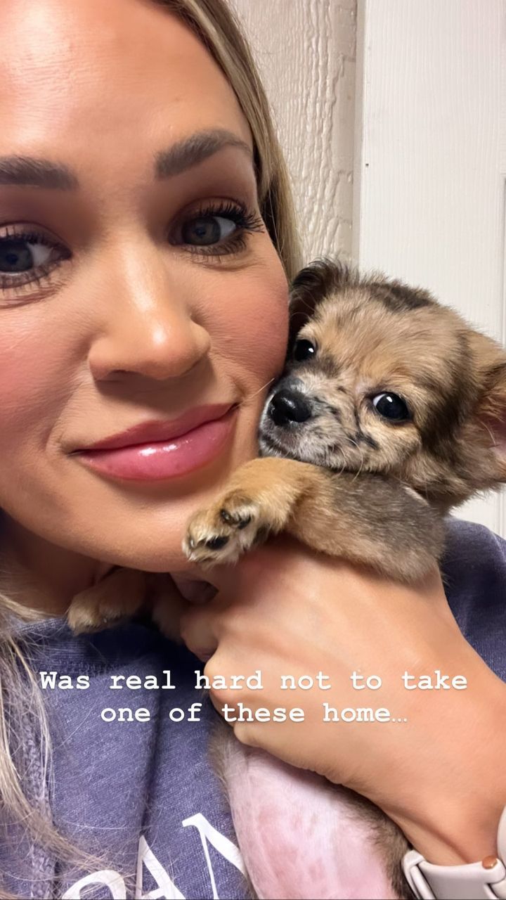 Carrie Underwood posing with a puppy