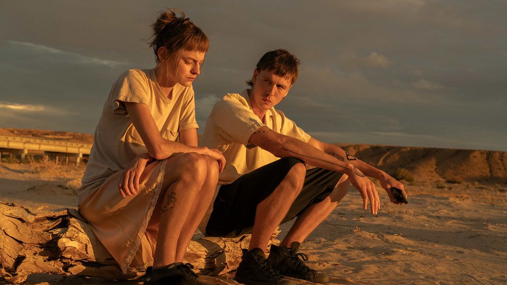 young woman and man sitting on beach