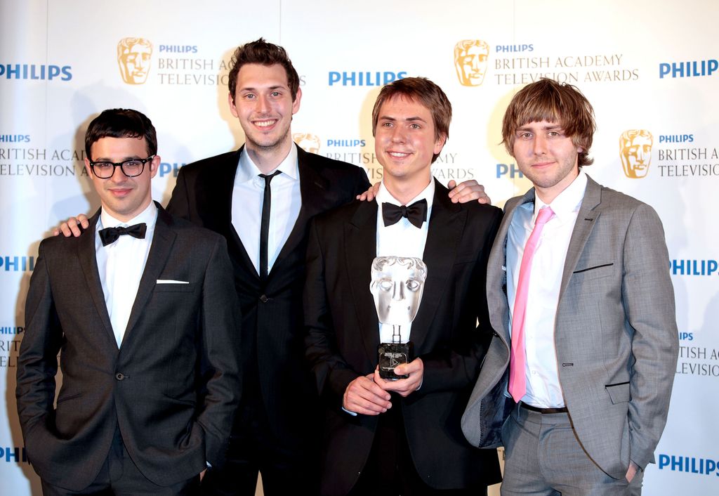 Simon Bird standing with Blake Harrison, Joe Thomas and James Buckley with a BAFTA Award