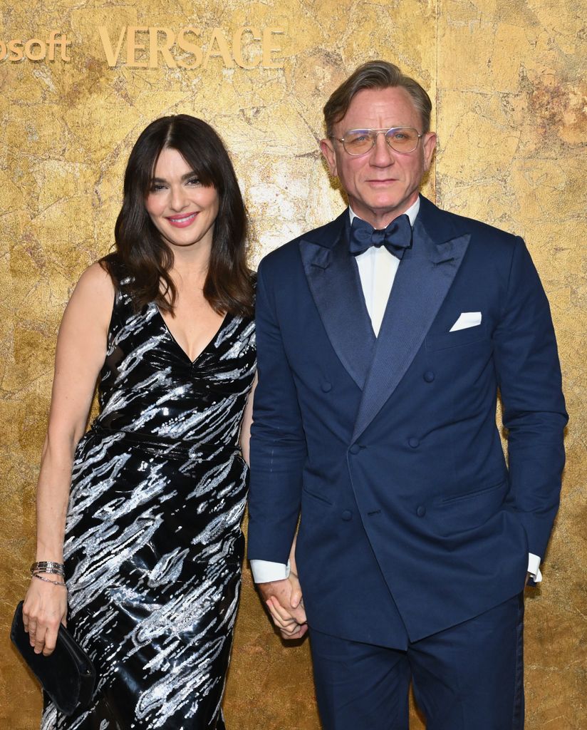 Rachel Weisz and Daniel Craig against gold backdrop