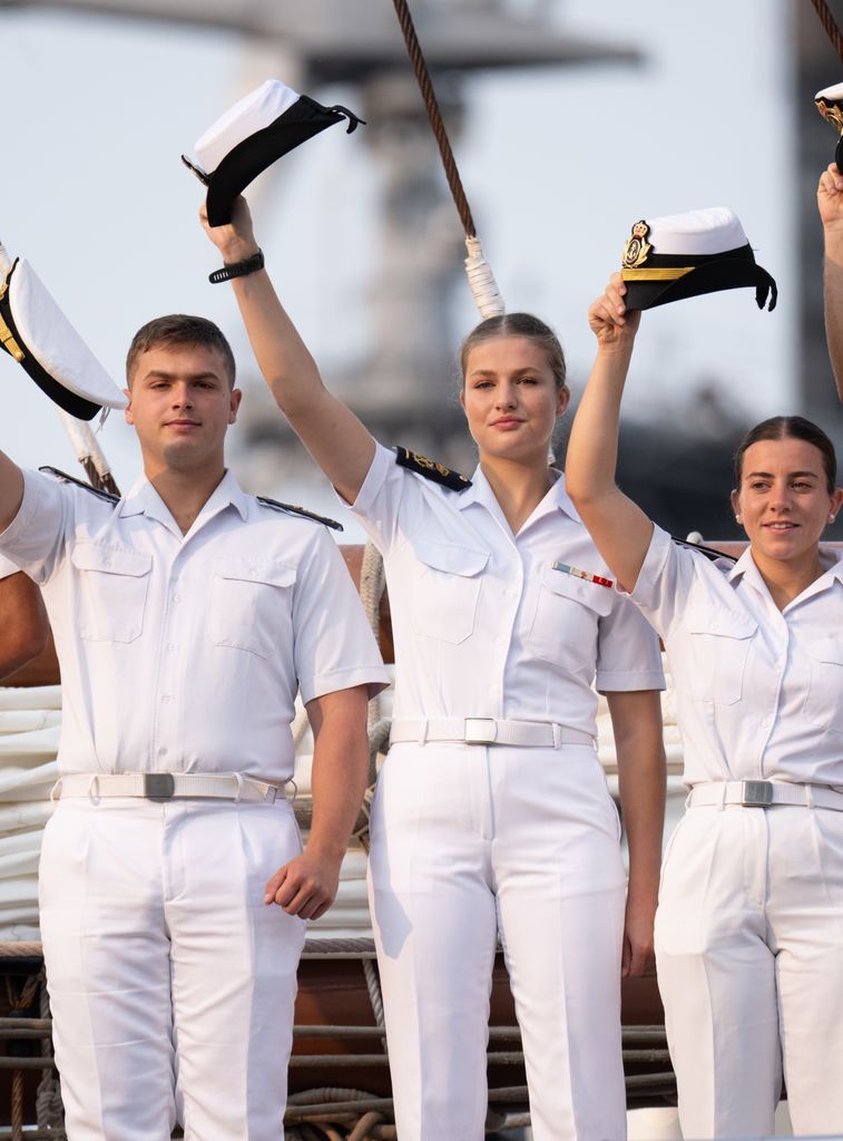 Princess Leonor and other naval cadets lifting their caps