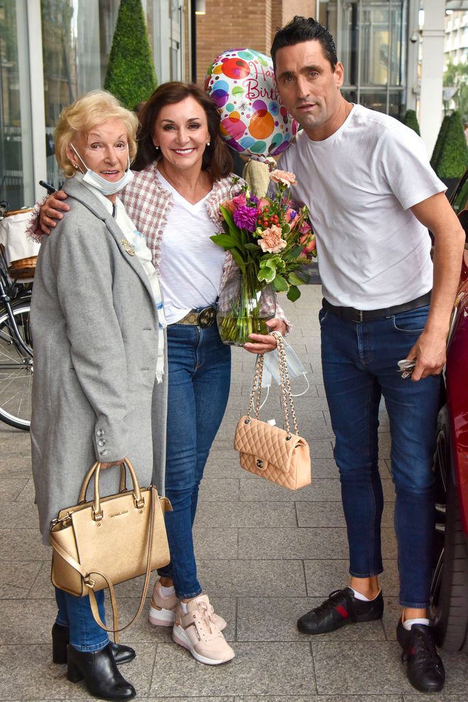 Shirley Ballas holding flowers and a balloon with mum Audrey and boyfriend Danny