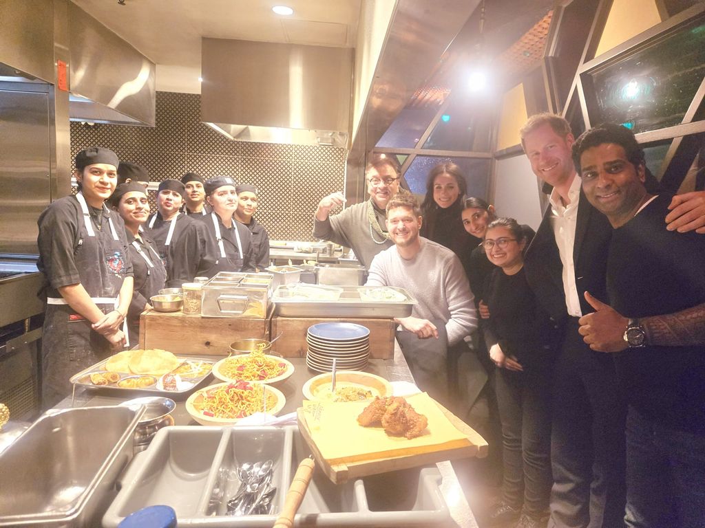 Prince Harry and Meghan Markle pose with Michael Buble and staff at Vij's