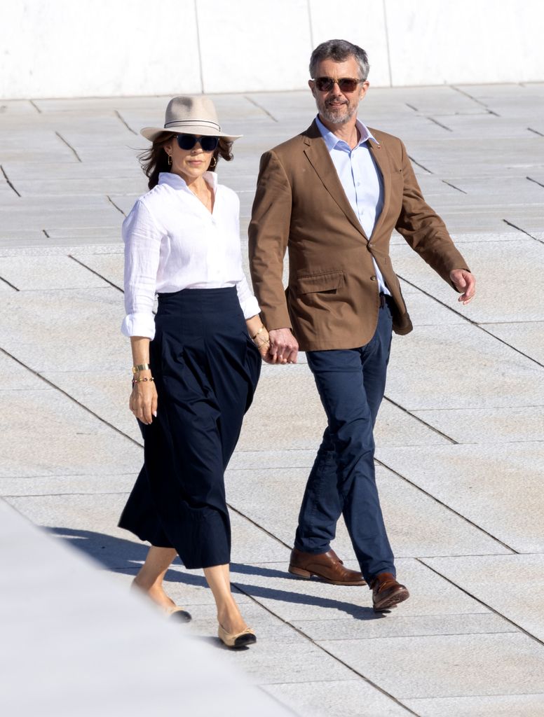 King Frederik and Queen Mary hold hands along the waterfront