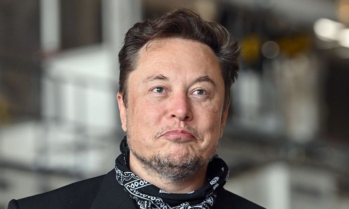 elon musk looking bemused in a black neckerchief