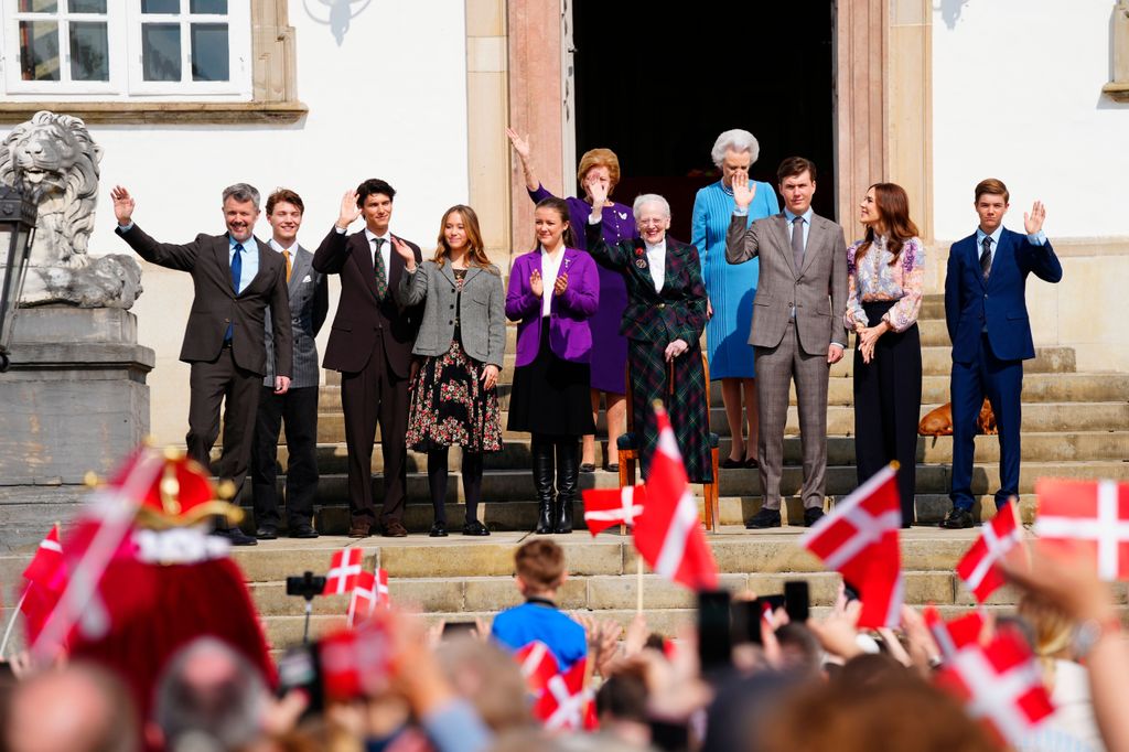 Crowds waving Danish flags in front of royals