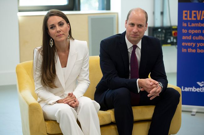 kate sits beside william wearing a white suit and the same shiny earrings