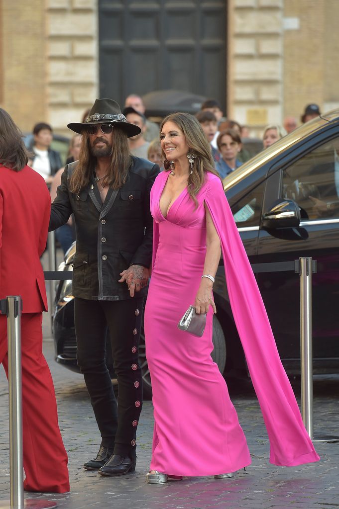 Elizabeth Hurley cosies up to Billy Ray Cyrus in hot pink gown for relationship first Elizabeth Hurley cosies up to Billy Ray Cyrus in hot pink gown for relationship first