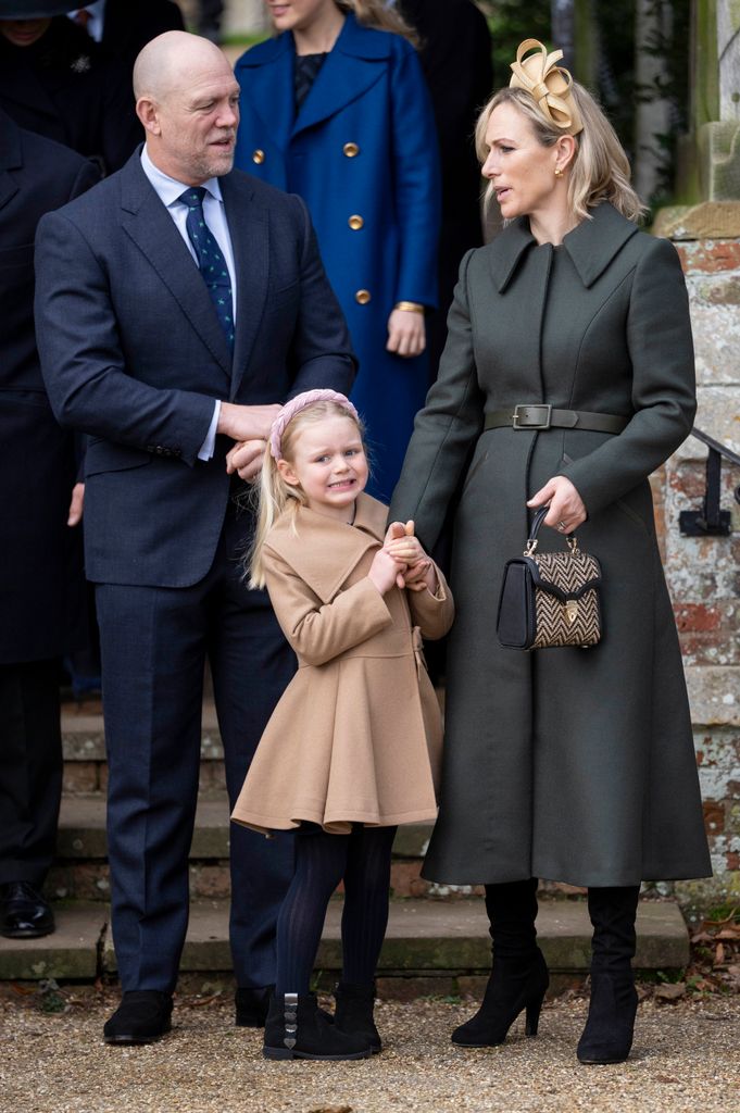 parents and daughter looking smart outside church 