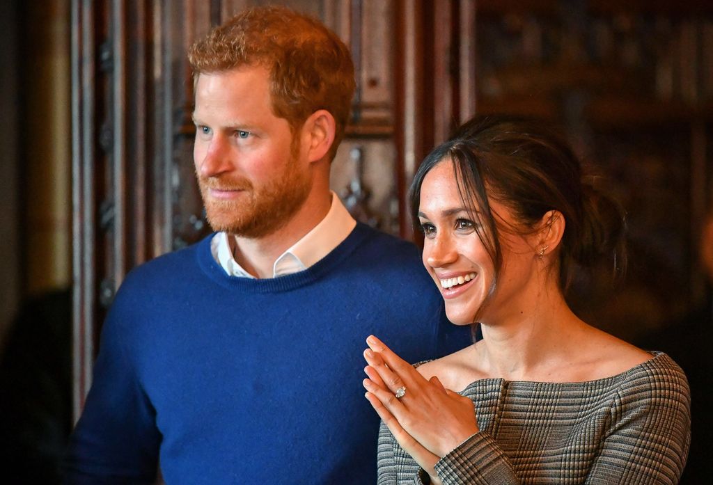 Prince Harry and Meghan Markle watch a performance by a Welsh choir in the banqueting hall during a visit to Cardiff Castle on January 18, 2018 in Cardiff, Wales