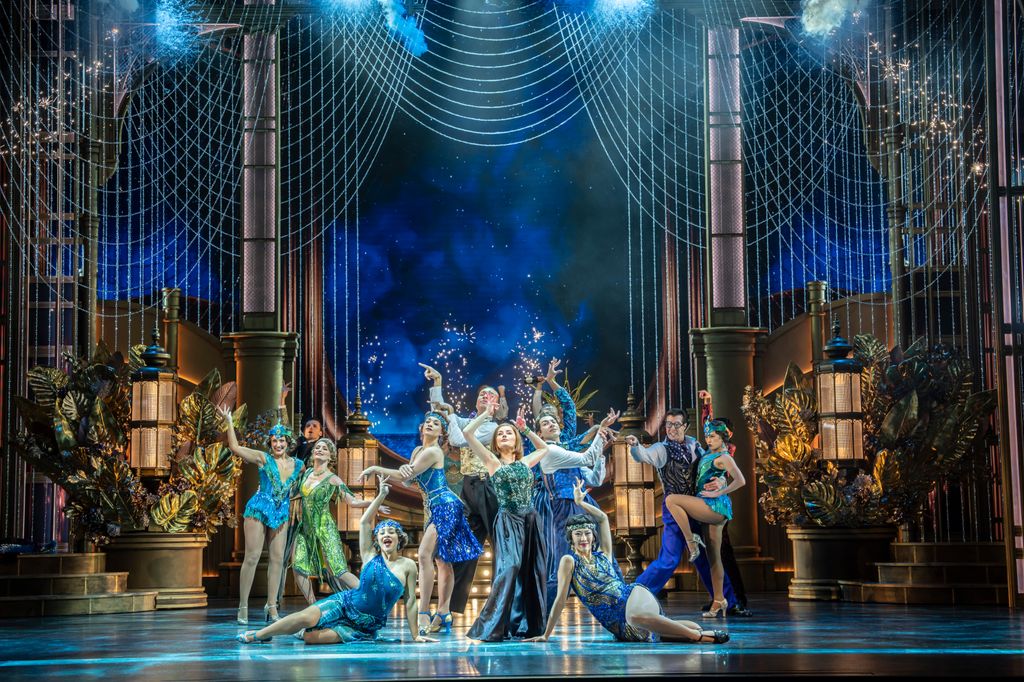 Amber Davies as Jordan Baker on stage with ensemble