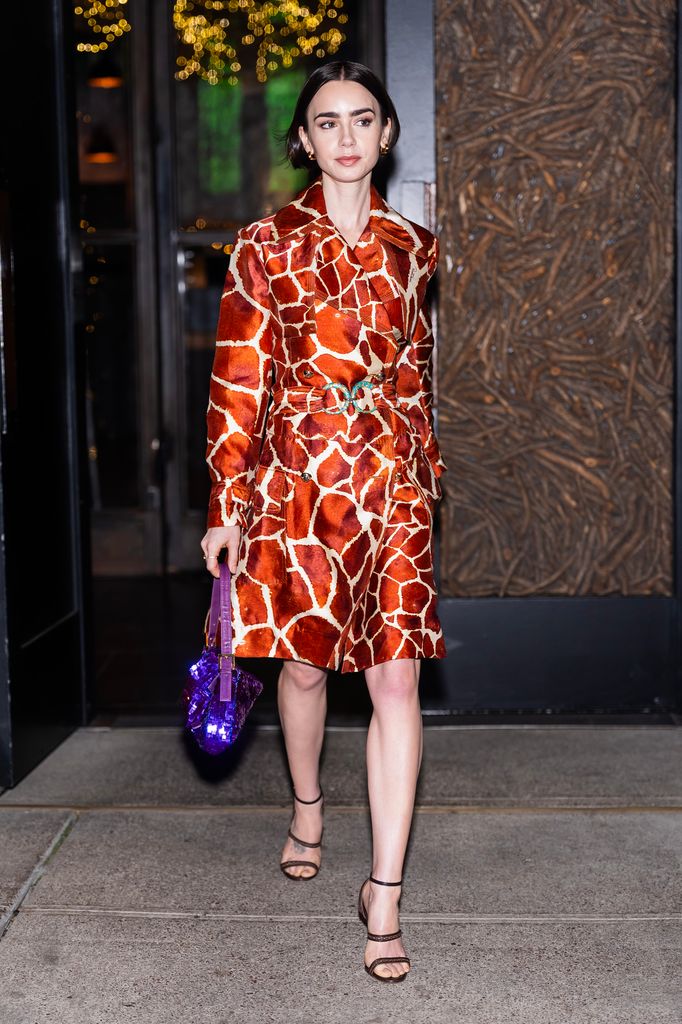 Lily Collins is seen in Midtown in giraffe print coat