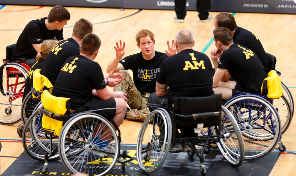 Prince Harry talks with wheelchair basketball players during the launch of the Invictus Games at the Copper Box Arena in the Queen Elizabeth Olympic Park on March 6, 2014 in London, England