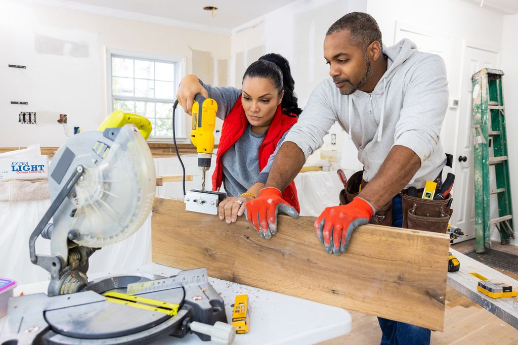 As seen on HGTV's Married to Real Estate, hosts Egypt Sherrod (L) and Mike Jackson (R) work together to prepare and hang floating shelves 