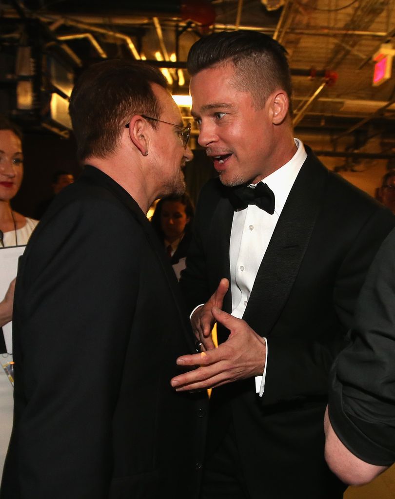 Bono of U2 and Brad Pitt speak backstage during the Oscars held at Dolby Theatre on March 2, 2014