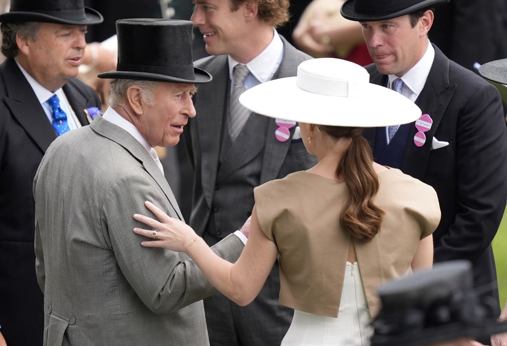 eugenie with one hand on uncle king charles's arm at royal ascot