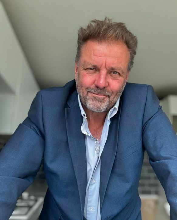Martin Roberts standing in a house