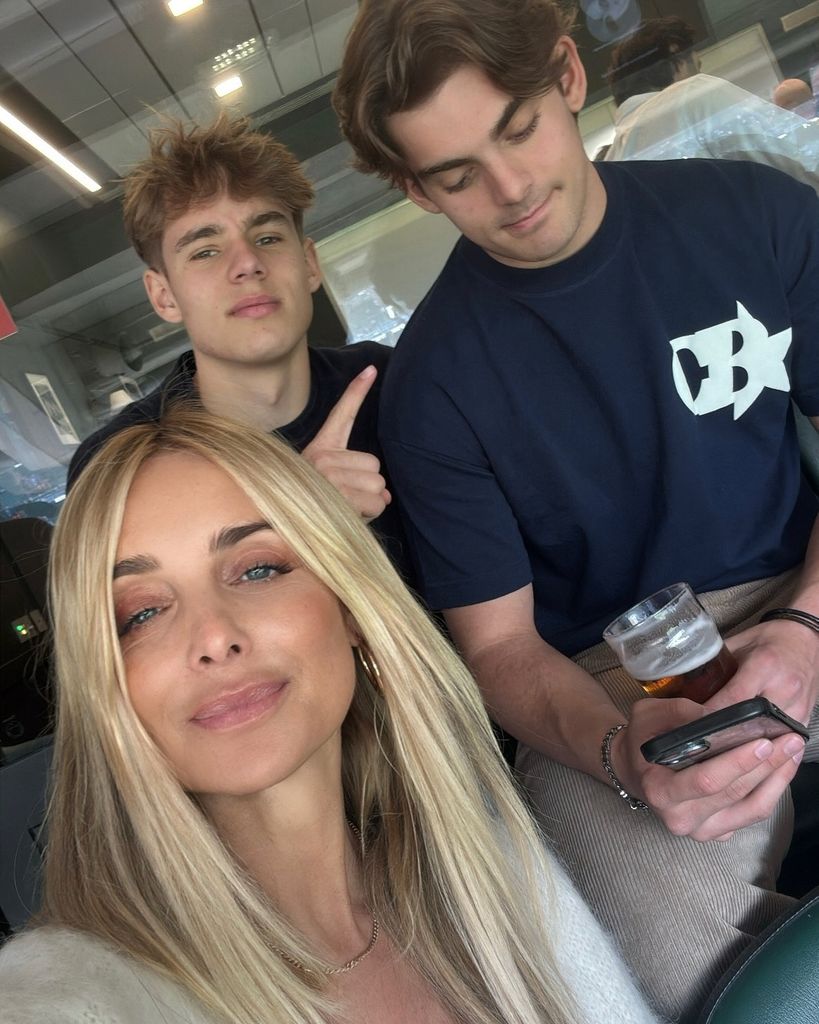 mother taking selfie with two sons 