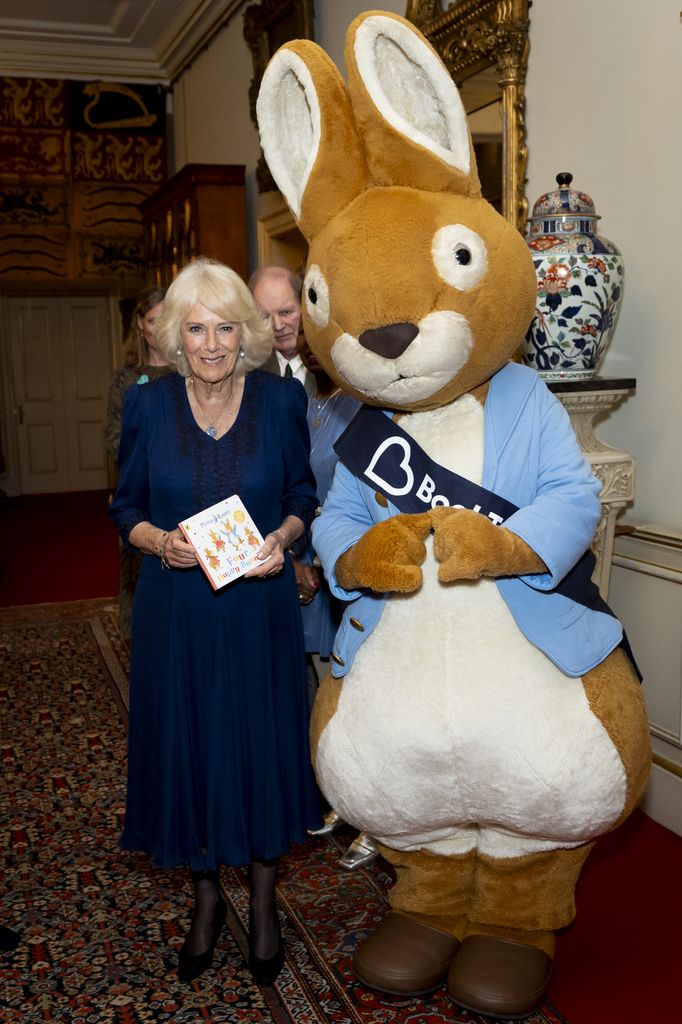 Queen Camilla standing next to a person in a Peter Rabbit costume