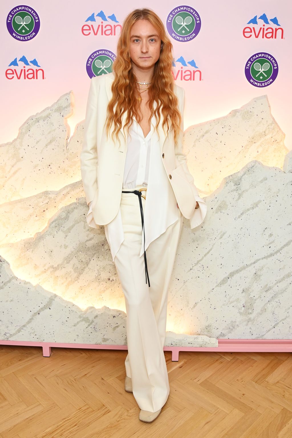 Fashion designer Harris Reed wore a chic cream suit with an asymmetricsal shirt and a draping waist belt