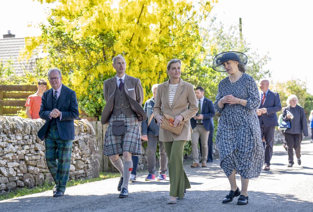 The Duke and Duchess of Edinburgh walk through the village with Lord Lieutenant Patrick Marriott (left) and Chair of Golspie Community Council Henrietta Marriott (right) during a visit to Golspie, Sutherland. 