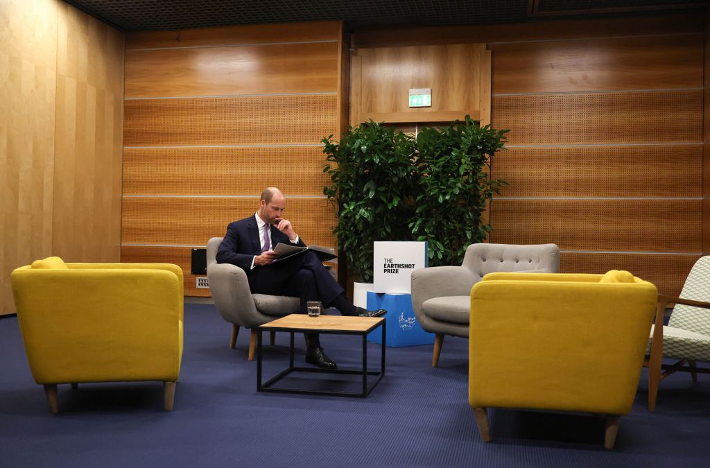 man on chair reading document
